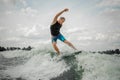 Handsome athletic man wakesurfing on the board against the sky Royalty Free Stock Photo