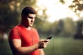 Handsome Athletic Man Wearing Earphones Holding His Smartphone Royalty Free Stock Photo