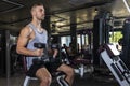 Handsome Athletic Men Exercising with dumbbells modern gym. Fitness men with naked torso doing workout