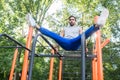 Handsome athletic young man exercising vertical leg raise in an Royalty Free Stock Photo