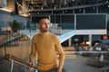 Handsome attractive Caucasian confident man businessman on business trip climbs the stairs in waiting room of departure terminal Royalty Free Stock Photo