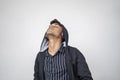 Handsome attractive indian man in black hoodie wear wireless music headphone,closed eyes feel the music standing against white Royalty Free Stock Photo