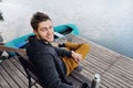 handsome attractive man on the wooden pier at the lake, lifestyle