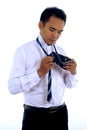 Handsome attractive young Asian businessman dressing,making tie