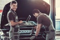 Handsome auto service workers Royalty Free Stock Photo