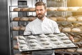 Handsome baker holding tray full of freshly baked croisants Royalty Free Stock Photo