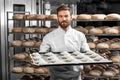 Handsome baker holding tray full of freshly baked croisants Royalty Free Stock Photo