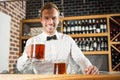 Handsome bar tender holding a pint Royalty Free Stock Photo