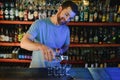 Handsome bar tender standing behind his counter in a pub Royalty Free Stock Photo
