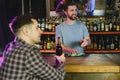Handsome bar tender standing behind his counter in a pub Royalty Free Stock Photo