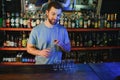 Handsome bar tender standing behind his counter in a pub Royalty Free Stock Photo