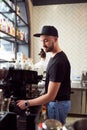 Male barista working on coffee machine