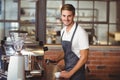 Handsome barista making a cup of coffee Royalty Free Stock Photo