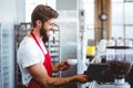 Handsome barista using the coffee machine