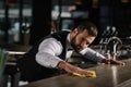 handsome bartender cleaning bar counter