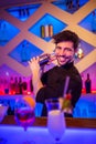 Handsome bartender preparing cocktail
