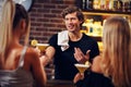 Handsome bartender serving cocktails in a pub Royalty Free Stock Photo