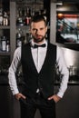 handsome bartender standing and looking