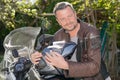 Handsome beard man in brown motorbike jacket motorcycle helmet in hands