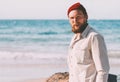 Handsome beard man walking on ocean beach summer traveling vacations