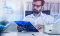 Handsome beard trader in glasses analyzing stock graph chart under the bases of fundamental analysis, front view businessman