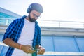 Handsome bearded brunette arabian man listen musics outdoor street Royalty Free Stock Photo