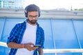 Handsome bearded brunette arabian man listen musics outdoor street Royalty Free Stock Photo