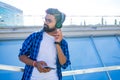 Handsome bearded brunette arabian man listen musics outdoor street Royalty Free Stock Photo