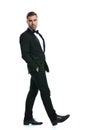 Handsome bearded businessman in black tuxedo holding hands in pockets Royalty Free Stock Photo