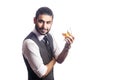 Handsome bearded businessman holding a glass of whiskey.