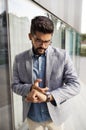 Handsome bearded businessman serious, looking his wrist watch Royalty Free Stock Photo