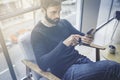 Handsome bearded caucasian man in black pullover using mobile phone application for mobile blogging. Confident young Royalty Free Stock Photo