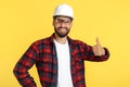 Handsome bearded engineer or constructor man in casual outfit show good gesture over yellow background. Royalty Free Stock Photo
