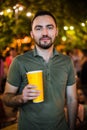 Handsome Bearded European Man Drinking coctail or beer at outdoor Street Cafe night party in park Royalty Free Stock Photo