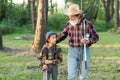 Handsome bearded grandfather spending leisure with his grandson going fishing. Family and hobby time concept.