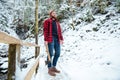 Handsome bearded lumberjack holding axe in mountain winter forest Royalty Free Stock Photo