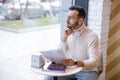 Attentive bearded man looking at big window Royalty Free Stock Photo