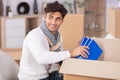 handsome bearded man in casual clothes packing books Royalty Free Stock Photo