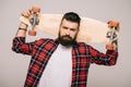 Handsome bearded man in checkered shirt posing with longboard isolated Royalty Free Stock Photo