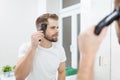 Handsome man cutting his own hair with a clipper Royalty Free Stock Photo