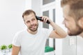 Handsome man cutting his own hair with a clipper Royalty Free Stock Photo