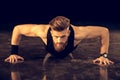 Handsome bearded man doing push ups exercise on black Royalty Free Stock Photo