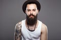 Handsome Bearded Man in Hat. tattoo on the hand Royalty Free Stock Photo