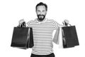 Handsome man holding up paper shopping bags. holidays shopping time concept. black friday sales. presents for friends Royalty Free Stock Photo