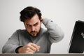 Handsome man looking in mirror, applying wax on his hair, head shot close up. Well groomed young guy doing hair styling. Royalty Free Stock Photo