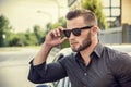 Handsome bearded man next to car in sunglasses Royalty Free Stock Photo