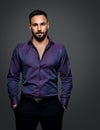 Handsome Bearded Man Portrait. Elegant Classic Fashion Style Men wearing Purple Shirt over Dark Gray. Confident Businessman