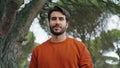 Handsome bearded man portrait smiling to camera in park. Guy holding backpack Royalty Free Stock Photo