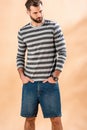 Handsome bearded man posing in striped sweatshirt Royalty Free Stock Photo