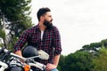 Handsome bearded man sitting on his motorcycle